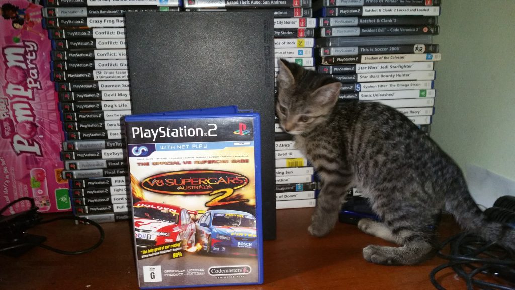 Bhaalgorn (Kitten) inspects a copy of the game.